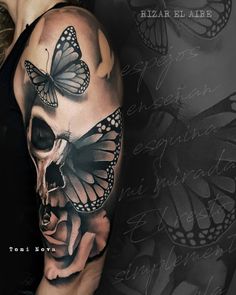 a woman's arm with butterflies on it and a skull in the middle,