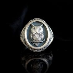 Special Design Oval Silver Owl Ring This unique oval ring combines the nobility of silver and the mysterious charm of the owl in magical harmony. From ancient mythologies to the present day, the owl has been associated with wisdom, prophecy and the keeper of secrets. For this reason, the ring not only elevates its owner's personal style, but also offers a comfortable wear with its oval shape that fits perfectly on your finger. The subtle relief patterns adorning the sides of the ring not only ad Collectible Sterling Silver Oval Ring, Antique Silver Oval Engraved Ring, Antique Silver Engraved Oval Ring, Silver Oval Engraved Ring For Gift, Antique Oval Engraved Silver Ring, Silver Oval Engraved Ring With Engraving Option, Unique Oval Sterling Silver Engraved Ring, Unique Oval Engraved Ring As A Gift, Unique Oval Engraved Ring For Gift