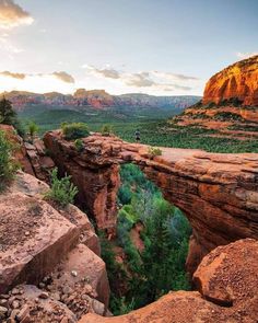 the sun is setting over canyons and cliffs