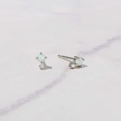 These opal studs are super cute and dainty! They are small, so are perfect for a minimalist look, for 2nd + piercings, or even for kids! Made of 925 Sterling Silver Sold as a Pair Measures 5 mm Push Back Closure Hypoallergenic and nickel free Made of lab created opal, and highest grade cz stone Minimalist White Opal Earrings, Minimalist Opal Earrings, Dainty White Piercings As Gift, Minimalist Hypoallergenic Opal Earrings, Minimalist Hypoallergenic White Piercings, White Dainty Nickel-free Cartilage Earrings, Dainty White Nickel-free Cartilage Earrings, Dainty Tiny White Cartilage Earrings, Dainty Nickel-free White Piercings