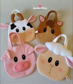 four cow and pig shaped purses sitting on top of a table