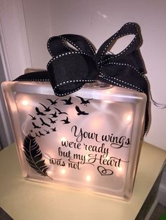 a lighted glass block with a black ribbon on it that says, your wings were ready but my heart was not