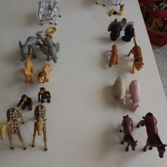 many toy animals are arranged on a table