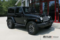 a black jeep parked in front of a building