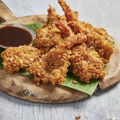 fried food on a wooden plate with sauce