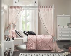 a bedroom decorated in pink and black