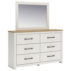 a white dresser with drawers and a mirror