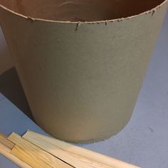 a brown pot sitting on top of a table next to a pair of chopsticks