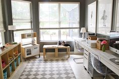 a living room filled with lots of furniture and windows covered in shades of grey, white and yellow