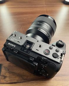 a camera sitting on top of a wooden table