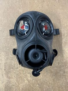 a gas mask sitting on top of a wooden floor