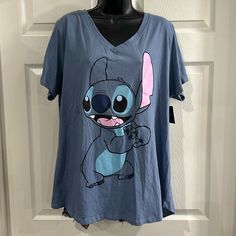 2x Disney V Neck Short Sleeve Tshirt. Blue. 52% Cotton And 48% Polyester. Length Is 28 Inches And Bust Is 48 Inches. Some Of The Stitching On The Vneck Look Like It’s Coming Loose. Cute Blue T-shirt For Loungewear, Disney Cartoon Print Relaxed Fit Tops, Relaxed Fit Disney Cartoon Print Tops, Blue Cute T-shirt For Loungewear, Relaxed Fit Short Sleeve Tops For Disney Fan Events, Disney Crew Neck Top With Relaxed Fit, Relaxed Fit Character Print Tops For Disney Fans, Relaxed Fit Tops With Character Print For Loungewear, Casual Character Print T-shirt For Loungewear