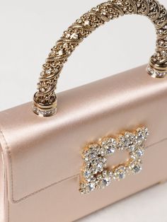 Find ROGER VIVIER Mini Bag on Editorialist. This Roger Vivier mini bag features a top handle and a detachable chain strap. The bag has a buckle closure and is embellished with crystals. It can be carried on the shoulder or worn crossbody. Luxury Event Clutch With Top Handle, Luxury Shoulder Bag For Events, Luxury Blush Shoulder Bag With Dust Bag, Luxury Embellished Event Bags, Luxe Evening Bag With Top Handle, Luxury Evening Bag With Pearl Handle For Events, Luxury Handheld Evening Bag, Luxury Top Handle Evening Bag For Events, Luxury Top Handle Shoulder Bag For Events