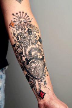 a person's arm with tattoos on it and an image of a heart in the middle