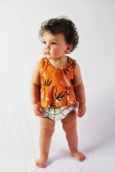 Our adobo earth tank has a swingy peplum and a slight high low hem. We just love this super cute print! It pairs perfectly with our grid bloomers! This top features cotton produced in the USA that is certified organic by global organic textile standards so you can feel good about dressing your baby in it! We serge all seams for added durability and strength. Here are our sizing measurements Size // Child height // Child weight 0-3 months // 17-23 inches // 7-12 pounds 3-6 months // 23-27 inches Playful Sleeveless Tops For Playdate, Sleeveless Summer Tops For Playdate, Bubble Shorts, Baby Tank, Summer Baby Clothes, Grid Print, Baby Bloomers, Clothing Summer