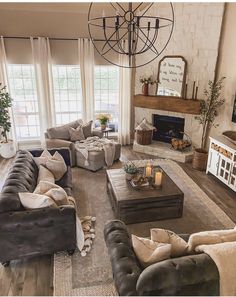 a living room filled with lots of furniture and a fire place in the middle of it