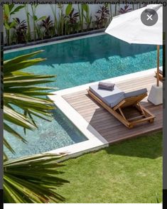 a pool with an umbrella and lounge chair next to it in the middle of grass