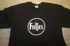 a black t - shirt with the words the feelies printed on it