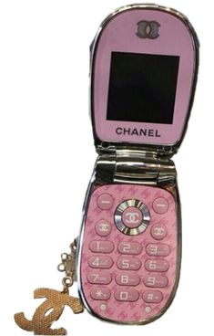 a pink cell phone with a key chain attached to it