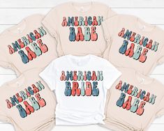 four american pride shirts are shown on a white wooden surface with the words american pride printed on them