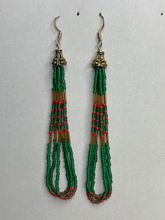 Made of glass seed beads and strong nylon B thread string, this pair is hung on sterling silver posts. Colorful Beaded Adjustable Jewelry For Festive Occasions, Green Dangling Beads Earrings For Festivals, Green Beaded Dangle Earrings With Large Beads, Green Large Beaded Dangle Earrings, Adjustable Round Beaded Earrings For Festive Occasions, Traditional Green Beaded Earrings For Festivals, Dangling Beads For Gifts And Festivals, Green Round Metal Bead Jewelry, Green Beads With Silver Details For Gifts