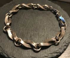 "A sterling vintage unusual twisted chain link bracelet.  Condition I see no problems-Length 8\", wt.- 19.6 grams.  Substantial  well designed-nice patina to the silver, can be polished brighter if so desired. Would be a spectacular interesting link bracelet for choice charms. There is a signature mark and 925 stamp on the link attached to the spring ring.   Easy, comfortable design to wear-working spring ring clasp." Twisted Chain, Oyster Pearl, Diy Wire Jewelry, Chain Link Bracelet, Spring Rings, Link Chain, Silver Bracelets, Wire Jewelry, Link Bracelets