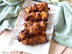 chicken skewers on a plate with lemon wedges