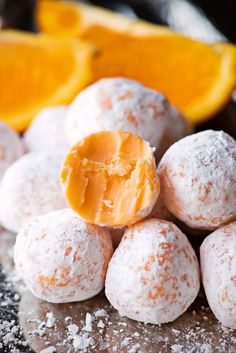 orange creamsice truffles are piled on top of each other