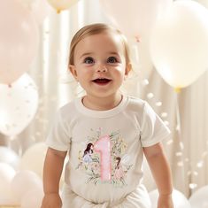 ✨ Celebrate Your Little One's Magical Milestone with Our Enchanting First Birthday Shirt! ✨ This charming shirt features whimsical watercolor fairies, delicate flowers, and a vibrant number one graphic, all crafted with love to create a magical look perfect for your little one's big day. 🌸 🌼 Soft and Comfortable: Made from 100% combed, ring-spun Cotton, this shirt is ultra-soft and gentle against your baby's skin, ensuring they stay comfortable throughout their special day. 🌟 Perfect for Photos: The beautiful design and vibrant colors make this shirt an ideal choice for birthday photo shoots, capturing precious memories you'll treasure forever. Create unforgettable birthday moments with our Fairy themed shirt! Order now and let your little one shine on their special day.  * Ribbed knitt Playful Crew Neck Top For First Birthday, Playful Short Sleeve Top For First Birthday, Playful Tops For First Birthday In Spring, Cute Short Sleeve Shirt For First Birthday, Playful T-shirt For First Birthday In Spring, Spring First Birthday Top With Short Sleeves, Crew Neck T-shirt For First Birthday In Spring, Spring Short Sleeve Top For First Birthday, Watercolor Fairies