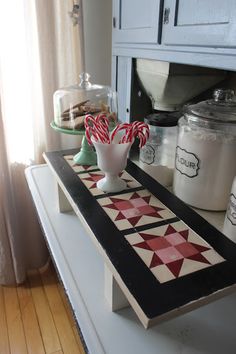 the kitchen counter is decorated with candy canes and candies in vases on it