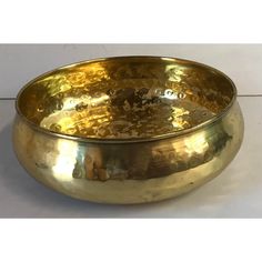 a large metal bowl sitting on top of a table