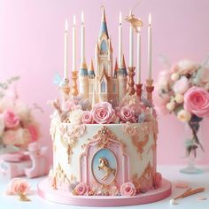 there is a cake decorated with pink roses and unicorns on the top, surrounded by candles