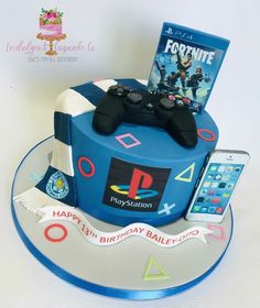 a birthday cake for a video game player and his cell phone is on the table