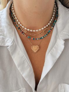 This pearl and gold bead necklace is your new favorite accessory this summer! Layer it with other fun necklaces for a fun and beachy look! Beaded Layering Necklace, Cheap Summer Pearl Necklace With Colorful Beads, Beaded Necklace Layering, Paperclip Necklace Layering, Trendy Beaded Chain Jewelry For Vacation, Trendy Gold Pearl Beaded Necklaces, Vacation Pearl Charm Strand Necklace, Gold Necklace With Pearl Pendant For Summer, Vacation Jewelry With Round Beaded Chain