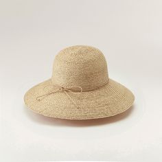 Helen Kaminski Women's Delphina Natural HAT50185 A modern taken on elegance, Delphina delivers minimal style at its best. Constructed from hand plaited raffia braid and taking up to three days to complete, this style is a timeless piece. Offering a classic round crown and down angled wide 10cm brim, it's finished with a hand rolled raffia tie and signature seed insignia. Styles can be adjusted with either a hand rolled raffia string around the crown or inner band and tie. You can expect to reduc Elegant Adjustable Braided Hat, Elegant Woven Sun Hat With Curved Brim, Elegant Woven Straw Hat With Curved Brim, Elegant Sun Hat With Curved Brim And Woven Detail, Elegant Sun Hat With Curved Brim, Classic Woven Straw Hat, Elegant Adjustable Woven Boater Hat, Elegant Woven Short Brim Hat, Elegant Woven Hat With Short Brim