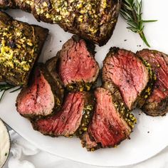 steaks with herbs and ranch dressing on a white plate