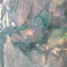 a close up view of marble with green and pink colors