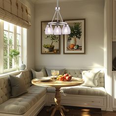 a small table with fruit on it in front of a couch and two framed pictures