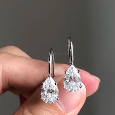 Classy Pear Cut Moissanite Drop Earrings, 14K Gold Teardrop Solitaire Earrings, Diamond Dangle Earring, Bridesmaid Earrings, Gift For Her ✥ Description of Earring: ● Moissanite Details: → Stone Shape: 𝐏𝐞𝐚𝐫 𝐂𝐮𝐭 → Stone Carat Weight : 𝟐.𝟎𝟎𝐂𝐓𝐖 (𝟐 𝐩𝐜𝐬 ) → Stone Measurement : 𝟕.𝟕𝐱𝟓.𝟕 𝐦𝐦 → Stone Color: Colorless → Stone Clarity: VVS → Stone Luster: Excellent → Stone Make: High Quality ● Metal Details: → Metal type: Gold → Metal Purity: 14 KT → Metal Tone: White → Metal Stamp: Yes ● Closure: Wire Wrapped ❁❁𝐂𝐮𝐬𝐭𝐨𝐦𝐢𝐳𝐚𝐭𝐢𝐨𝐧 𝐃𝐞𝐭𝐚𝐢𝐥𝐬❁❁ : ↣ Customized Designer Jewelry. ↣ We Offer All cuts which you dream to make with moissanite, lab grown, lab created diamonds. ↣ Updating every step of your ordered jewelry. ↣ All listed jewelry in our stores is made to order. Engagement Earrings, Solitaire Earrings, Diamond Dangle Earrings, Moissanite Earrings, Beautiful Engagement Rings, White Gold Earrings, Custom Earrings, Pear Diamond, Simple Earrings