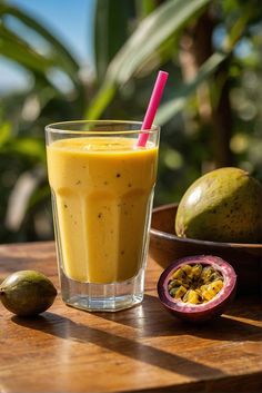 a smoothie in a glass next to some fruit