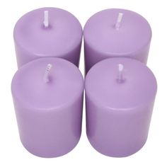 four purple candles sitting next to each other