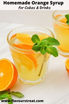 two glasses filled with orange syrup and garnished with mint