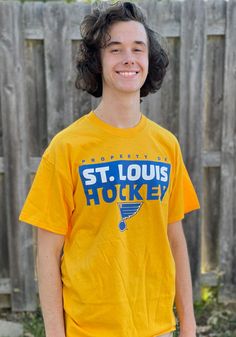 Show off your team pride in this St Louis Blues Gold Gain Ground Short Sleeve T Shirt! This STL Blues Short Sleeve Tee features a lightweight, cotton material with a crew neckline and screen printed team graphics. Make sure everyone knows you root for the Blues with this Gold STL Blues T Shirt. Long Live the Note! Relaxed crew design, Crew neckline, Screen print team graphics, Unisex fit, Great for the house, the game, or anywhere your fandom reigns, Fit: True to Size, 100% COTTON, Machine wash, Team-colored Cotton T-shirt For Game Day, Pre-shrunk Cotton Sports Fan T-shirt, Pre-shrunk Cotton T-shirt For Sports Fans, Casual Yellow T-shirt With Team Name, Cotton Crew Neck T-shirt For Sports Events, Game Day Fan Apparel Cotton T-shirt, Sports Fan T-shirt With Team Name In Cotton, Sports Fan Cotton T-shirt With Team Name, Casual Cotton Tops With Team Logo