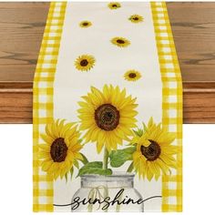 a yellow and white table runner with sunflowers