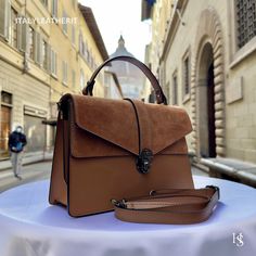 This bag has been made of the best genuine leather by local master crafters of Florence in Italy, designed for women who only accept premium Italian quality and luxury leather bags and modern Italian fashion. . Sizes: Width: 29cm/10.6 inch Height: 19cm/7.4 inch Depth: 7 cm/3.9 inch The story of this bag:  John was visiting Florence with his family and he wanted to find the perfect gift for his wife and daughters. He had heard about the exquisite leather craftsmanship in the city and was determin Luxury Brown Bags For Daily Use, Luxury Camel Top Handle Satchel, Modern Brown Flap Bag With Top Handle, Luxury Brown Briefcase With Top Carry Handle, Brown Flap Bag With Double Handle And Top Carry, Brown Flap Bag With Top Carry And Double Handle, Brown Flap Bag With Top Handle For Daily Use, Brown Top Handle Flap Bag For Daily Use, Elegant Brown Tote Flap Bag