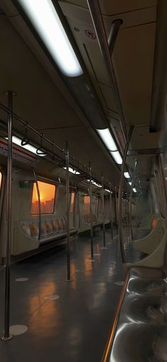 the interior of a subway train with its lights on at sunset or sunrise, as seen from inside