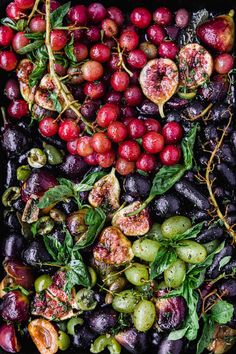 an assortment of fruits and vegetables in a black tray