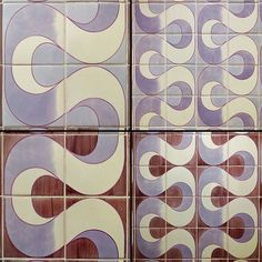 four tiles with purple and white swirls on them are arranged in the same pattern