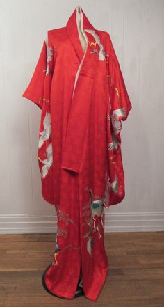 "Vintage red silk brocade Uchikake ceremonial kimono robe, jacket. Has metallic silver and gold embroidery. Elegant cranes, sign of good fortune, longevity and faithfulness. Made to be worn as outerwear. Long to have a train effect, hem is padded. Lined in white silk. Measures 69\" long and 51\" across the top from sleeve end to sleeve end." Vintage Red Kimono For Tea Ceremony, Ceremonial Vintage Kimono, Vintage Red Kimono For Wedding, Traditional Red Kimono For Tea Ceremony, Red Long Kimono For Wedding, Long Red Kimono For Wedding, Traditional Long Wedding Robe, Silk Kimono With Kimono Sleeves For Tea Ceremony, Traditional Red Silk Kimono