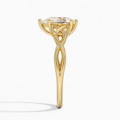 a yellow gold ring with an intricate design